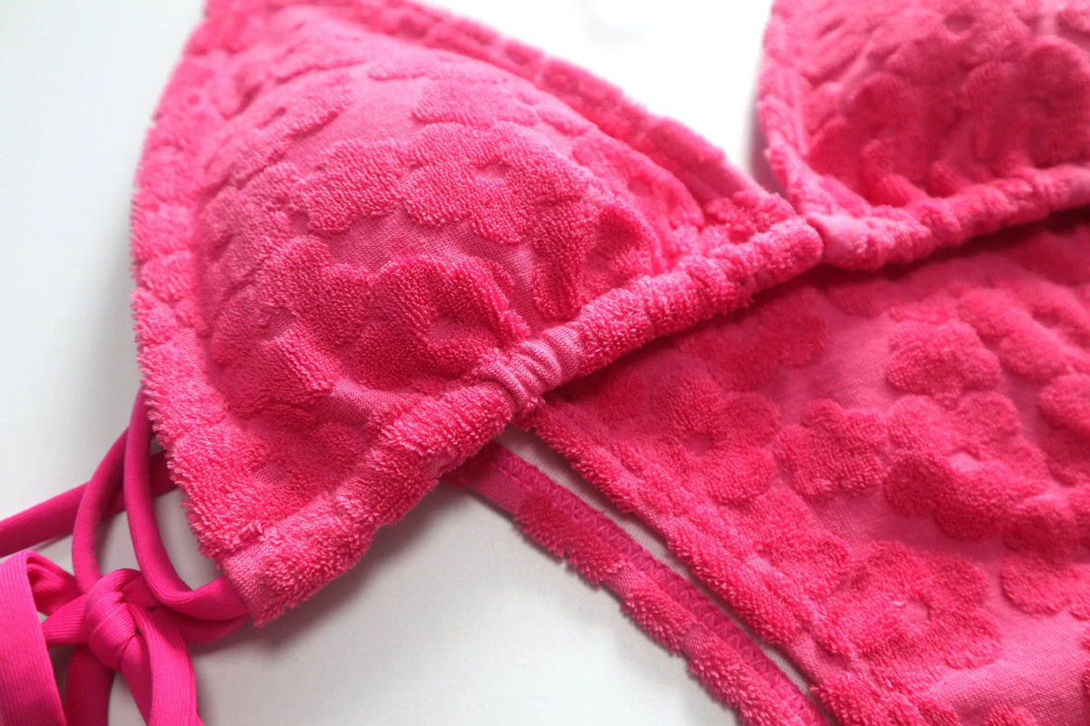 Women's bikini swimsuit with three-point lace-up detail in blue or rose red.