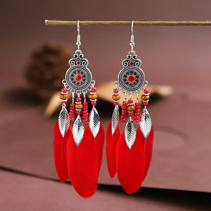 Round drop feather earrings in a bohemian leaf shape with patterned detail, shown in a light pink electroplated colour.
