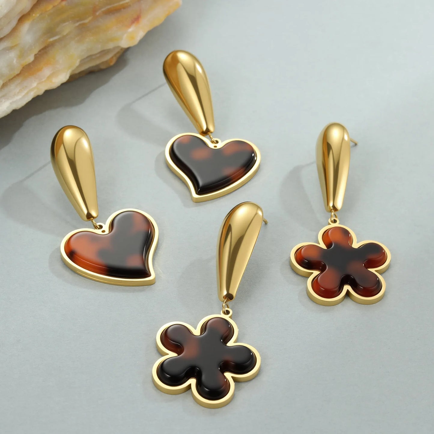 Women's tortoiseshell resin style earrings with 18K gold electroplated finish on stainless steel, heart and floral designs