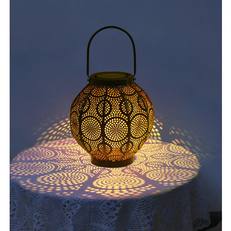 Solar-powered iron courtyard lamp with hollow decorative design and warm white LED lighting