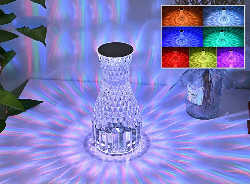 Vase-shaped crystal table lamp with remote control on a bedside table, showing diamond-like glow and USB charging port.