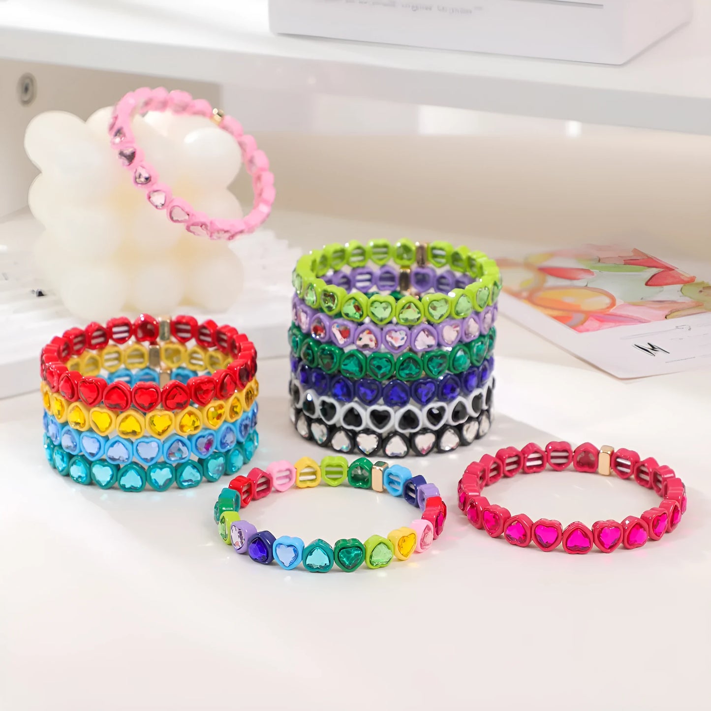 Colourful enamel heart shape on a silver-toned alloy stretch bracelet.