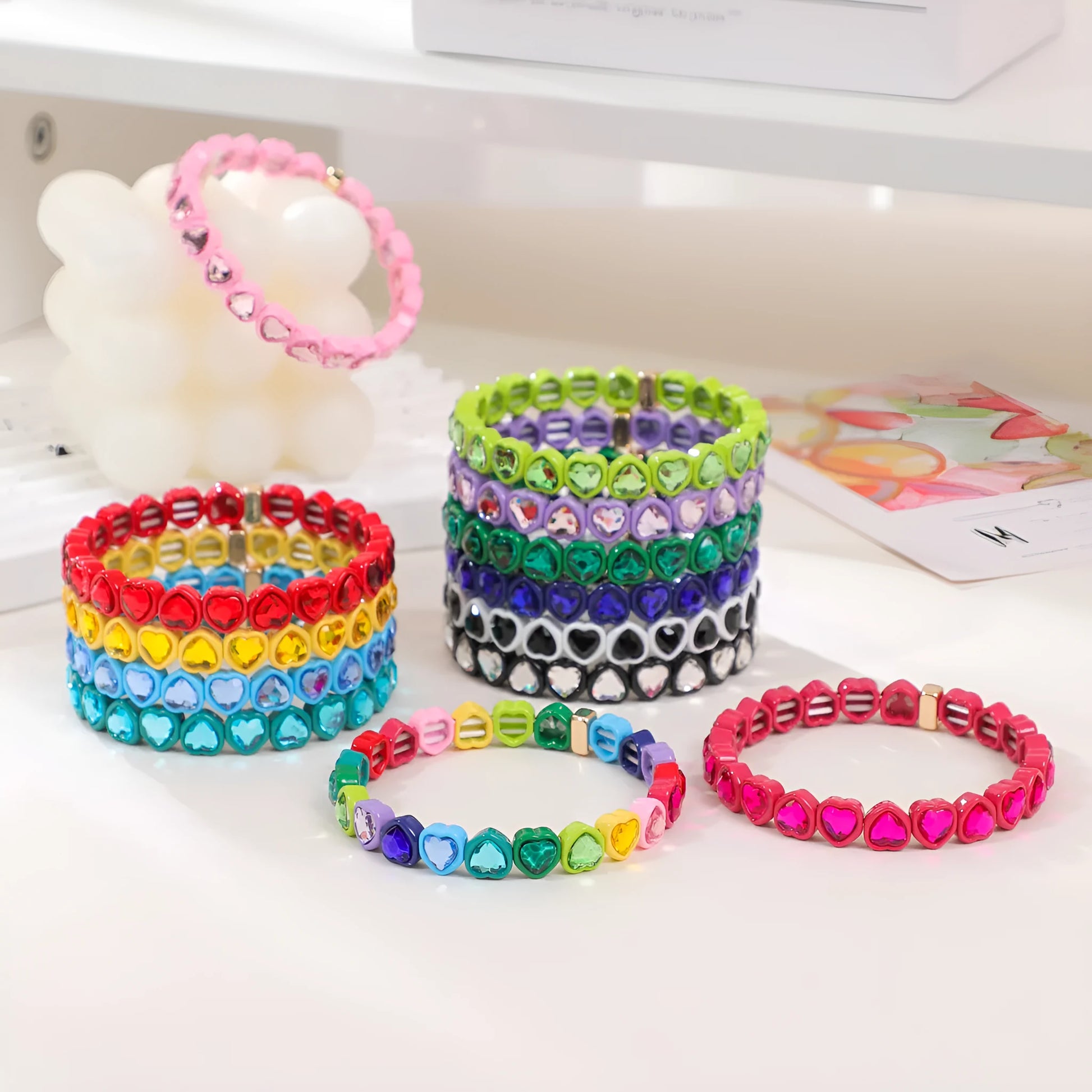 Colourful enamel heart shape on a silver-toned alloy stretch bracelet.