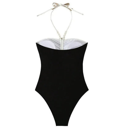 Women's black and white one-piece swimsuit with pearl spaghetti straps and a slimming silhouette.