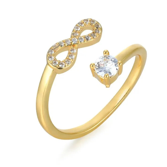 Open geometric ring with a zircon-encrusted letter 'A' in rose gold on a finger.