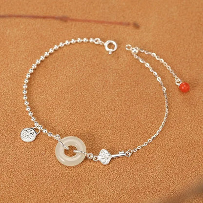 Silver women's bracelet with Hetian jade stones and a geometric peace buckle charm.