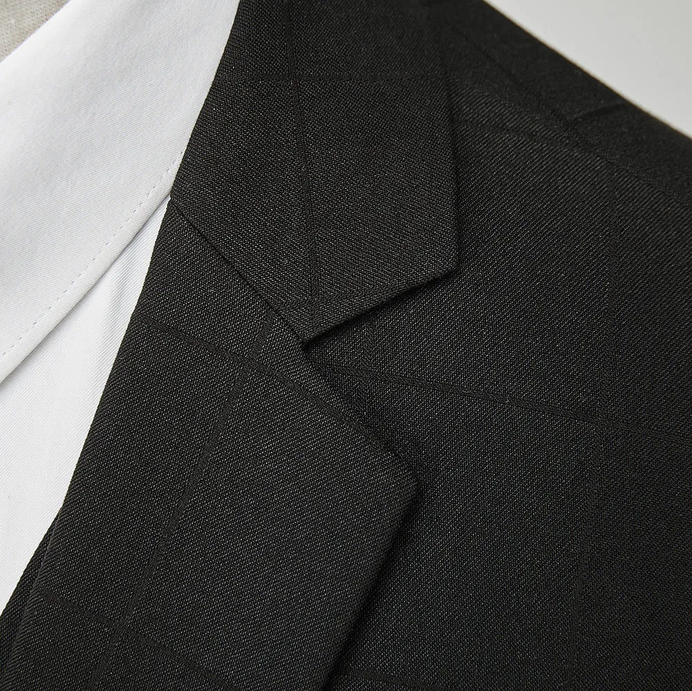 Man wearing a navy blue plaid slim-fit three-piece suit with jacket, waistcoat, and trousers