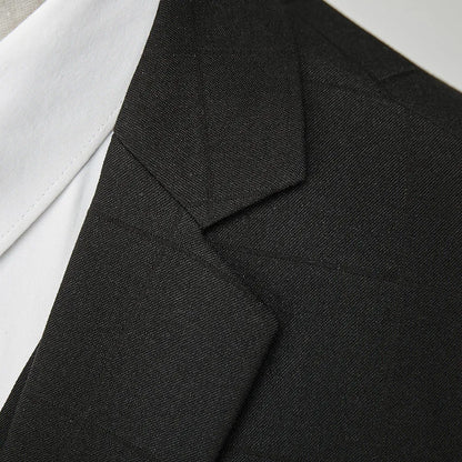 Man wearing a navy blue plaid slim-fit three-piece suit with jacket, waistcoat, and trousers