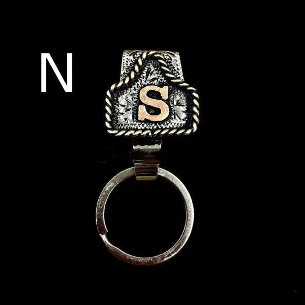Handmade cow tag design metal keychain on a keyring, shown in one of many available colours.