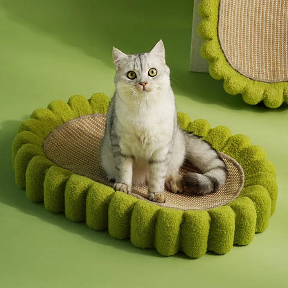 Green oval sisal cat scratching pad and lounge bed on a wooden floor.