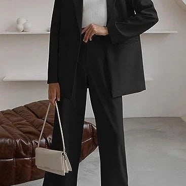 Tailored ladies' suit in various colours, featuring a jacket and trousers made of premium polyester fabric.