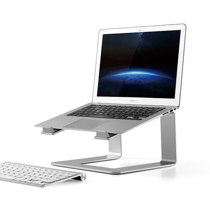 Black aluminium alloy laptop stand on a desk, showing its raised platform and open base design.