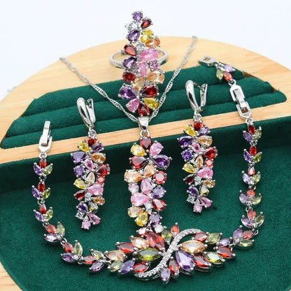 Vintage jewellery set with floral patterns showing necklace, bracelet, earrings and ring in olive green colour