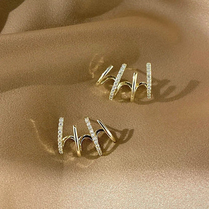 Pair of 925 sterling silver earrings with four-prong zircon stone settings in a geometric design