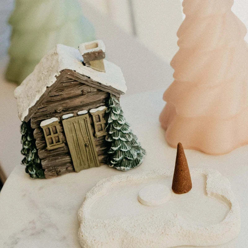 Rustic log cabin incense burner with intricate details, filling the air with soothing aromas