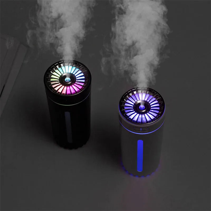 Black portable humidifier with LED lights beside car cup holder showing mist output