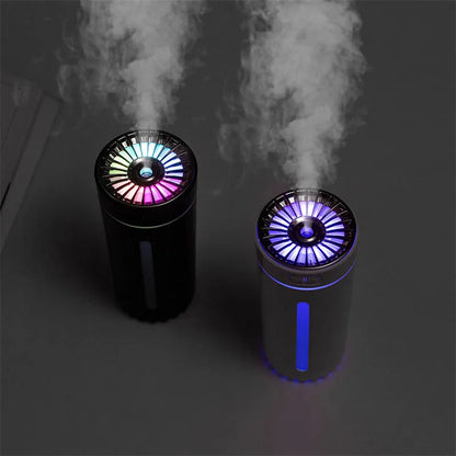 Black portable humidifier with LED lights beside car cup holder showing mist output
