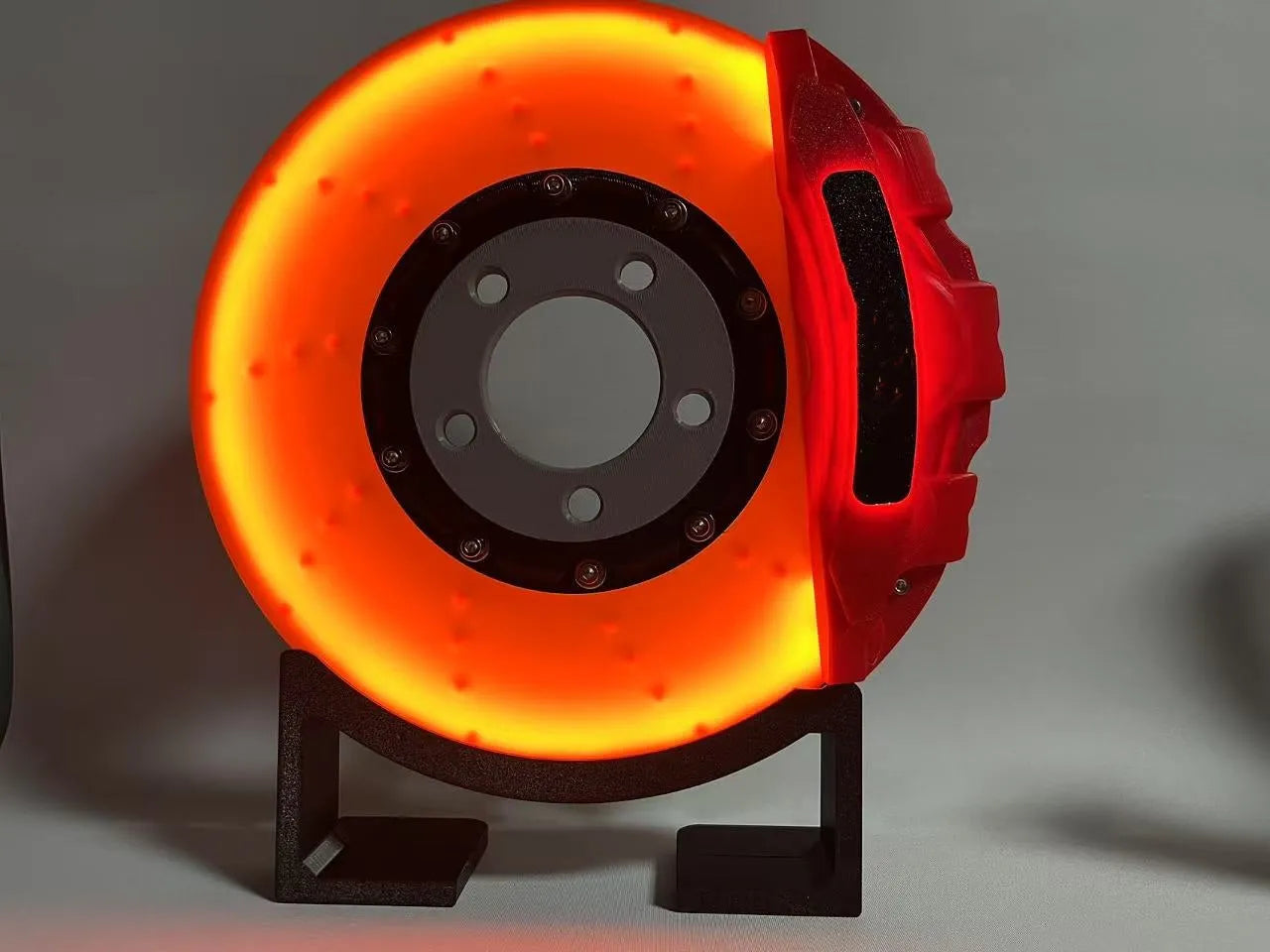 Brake disc design LED night light with caliper details in blue, red, or yellow colour options on desktop