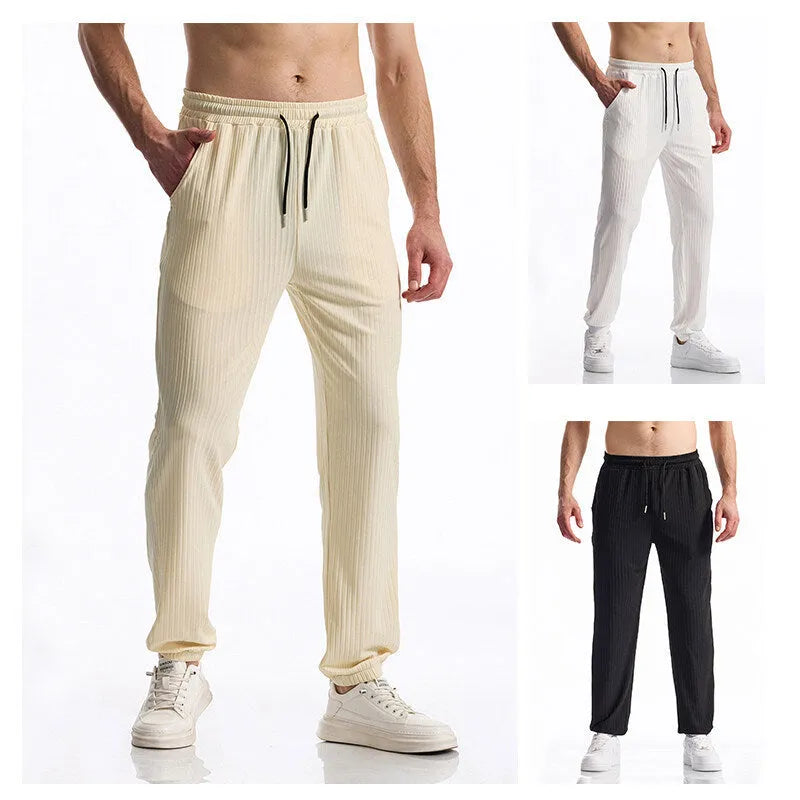 Casual trousers made from silky rib fabric in a baggy straight-leg cut with a mid-waist, elasticated drawstring closure, and available in black, white, or khaki for leisure wear in S to 3XL sizes