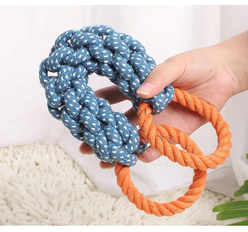 Blue braided bone-shaped cotton rope dog toy with two end rings on a white background.