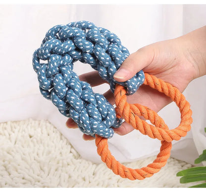 Blue braided bone-shaped cotton rope dog toy with two end rings on a white background.