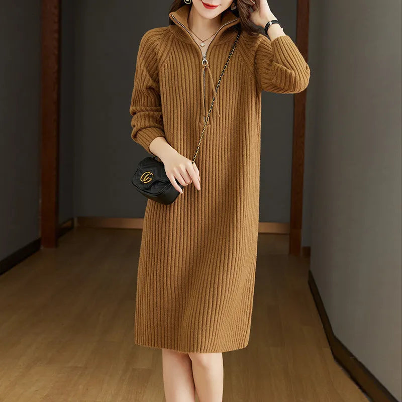 Beige half-zip woolen skirt with long sleeves, a stand collar, and a loose, straight midi silhouette.