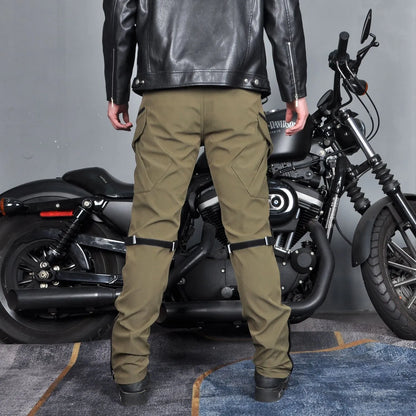 Motorcycle rider wearing green waterproof trousers with removable protective armour on knees and hips.