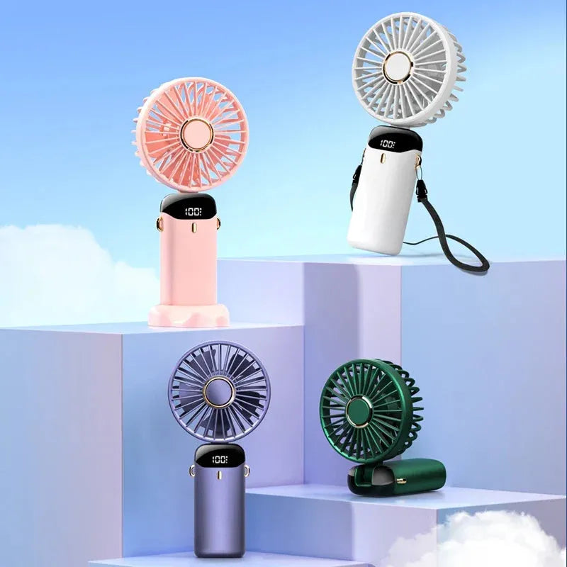 Blue foldable mini handheld electric fan showing its LED display and hanging lanyard.