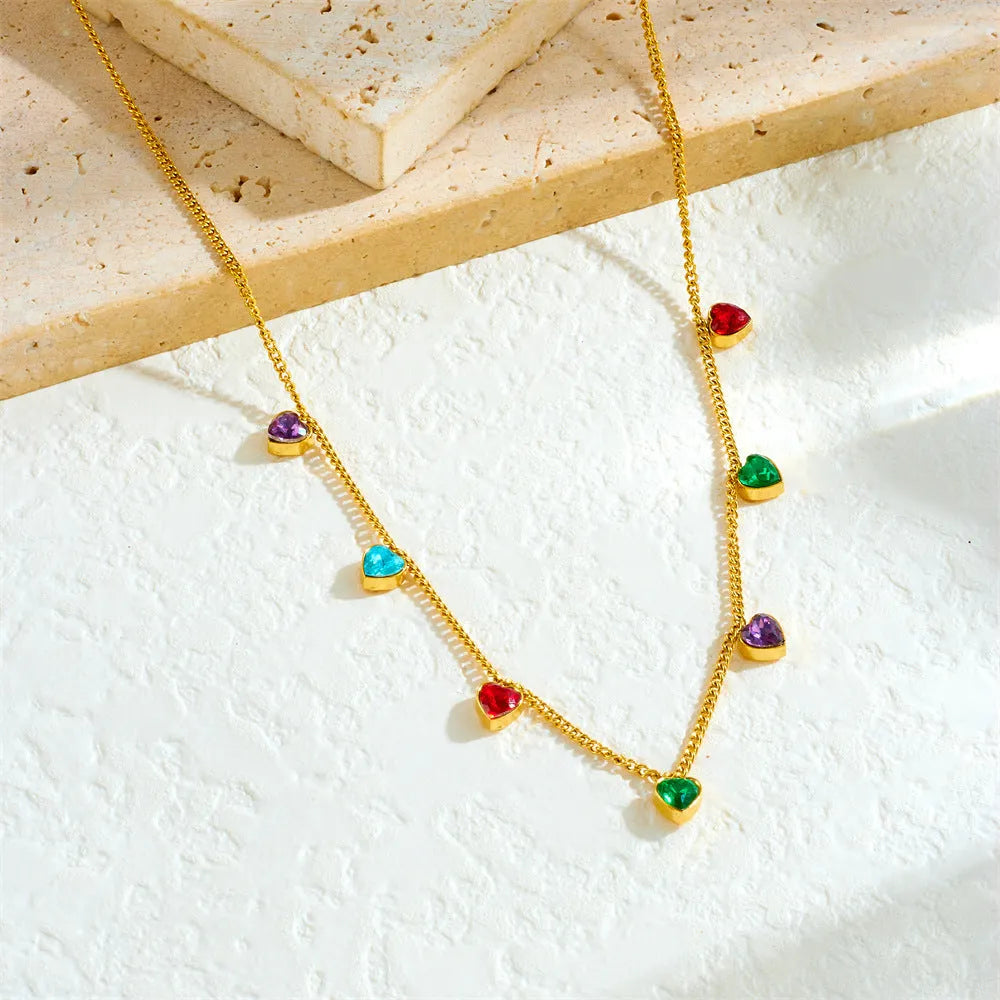 Women's gold-plated heart necklace with adjustable chain on white background
