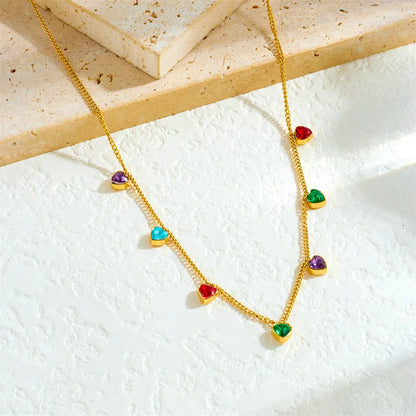 Women's gold-plated heart necklace with adjustable chain on white background