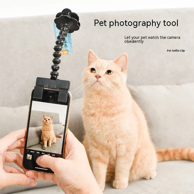 Multifunctional pet camera holder and selfie clip that securely attaches to your phone or mobile device and allows you to capture your furry friend's most playful moments with ease.