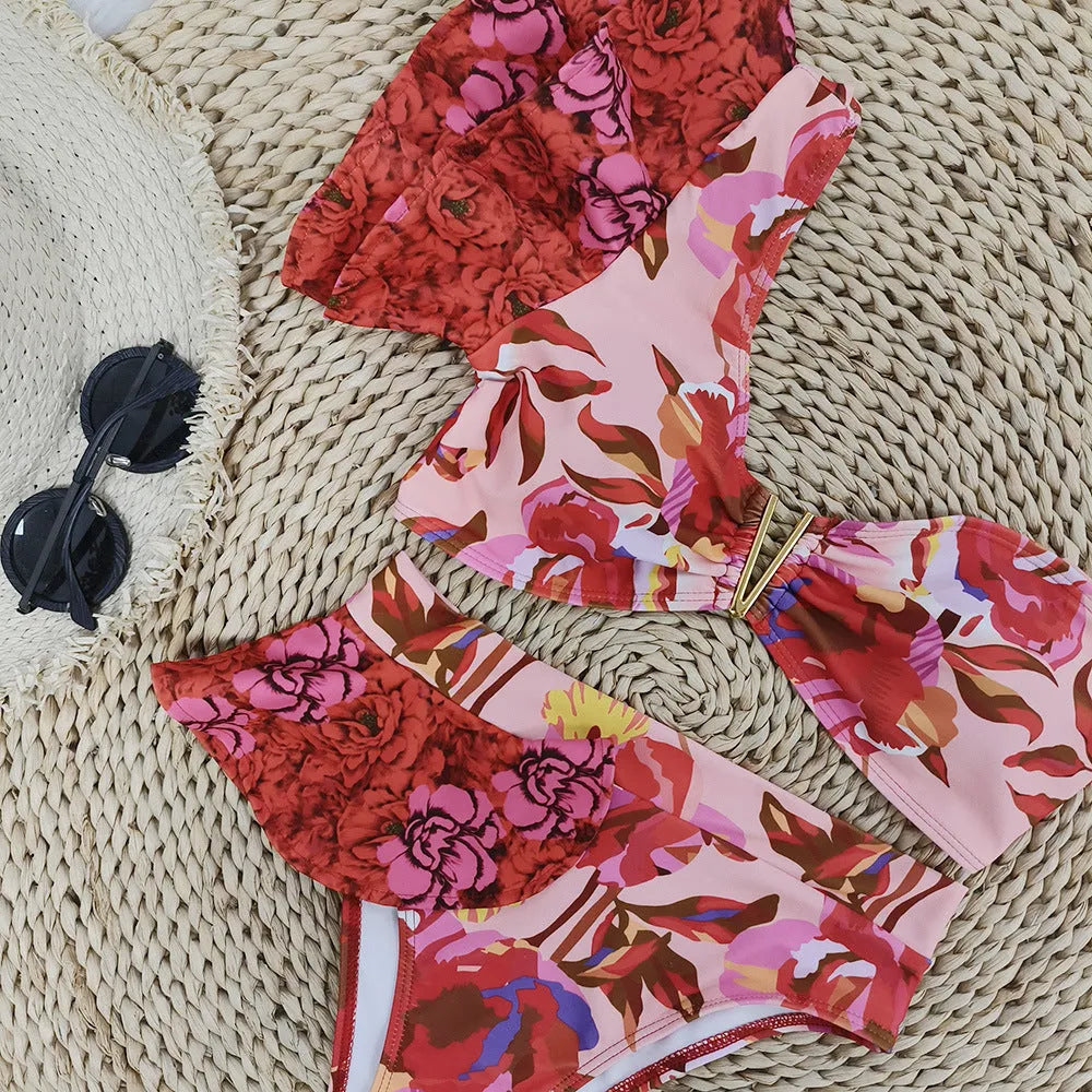 Women's one-shoulder ruffled high-waist bikini with pink background and red flower pattern