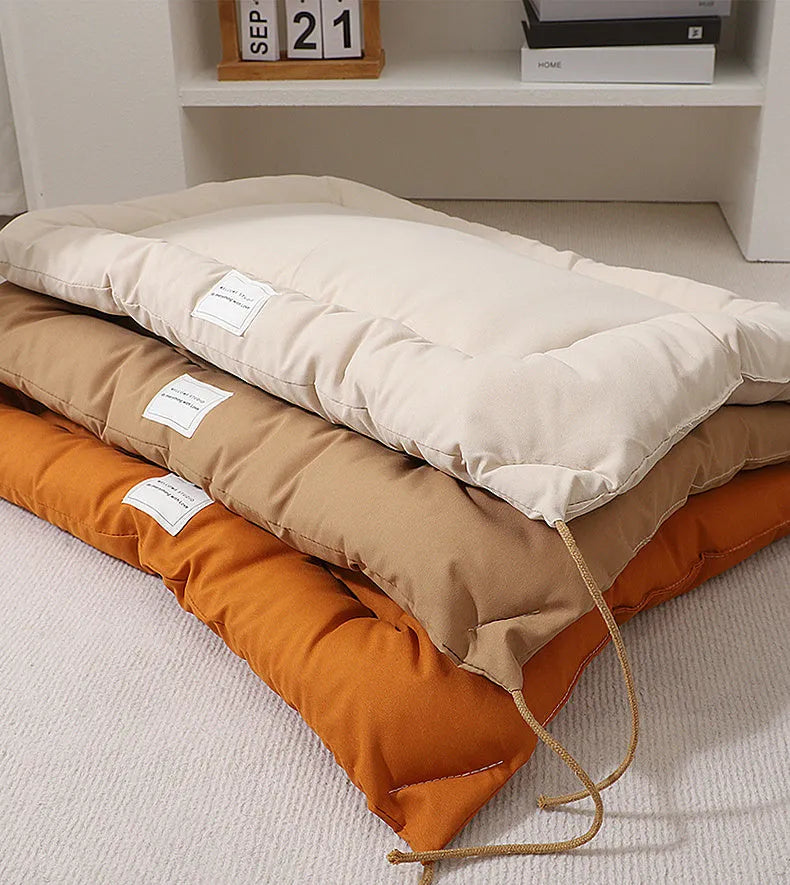 Beige cage cushion for dogs tied inside a metal crate, shown next to coffee and orange colour options.