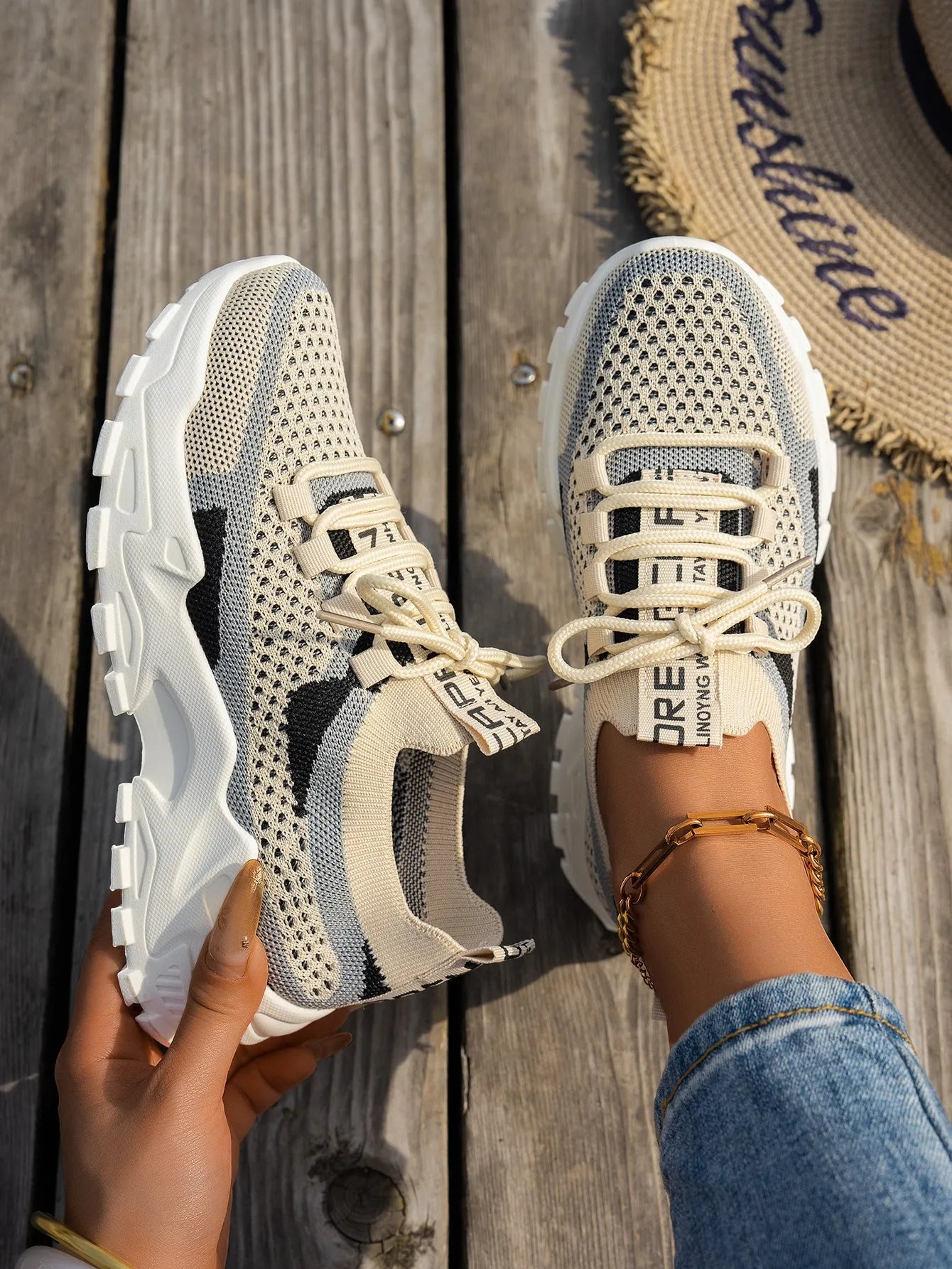 Women's Flyknit mesh lace-up sneaker in a grey colourway showing round toe and rubber sole.