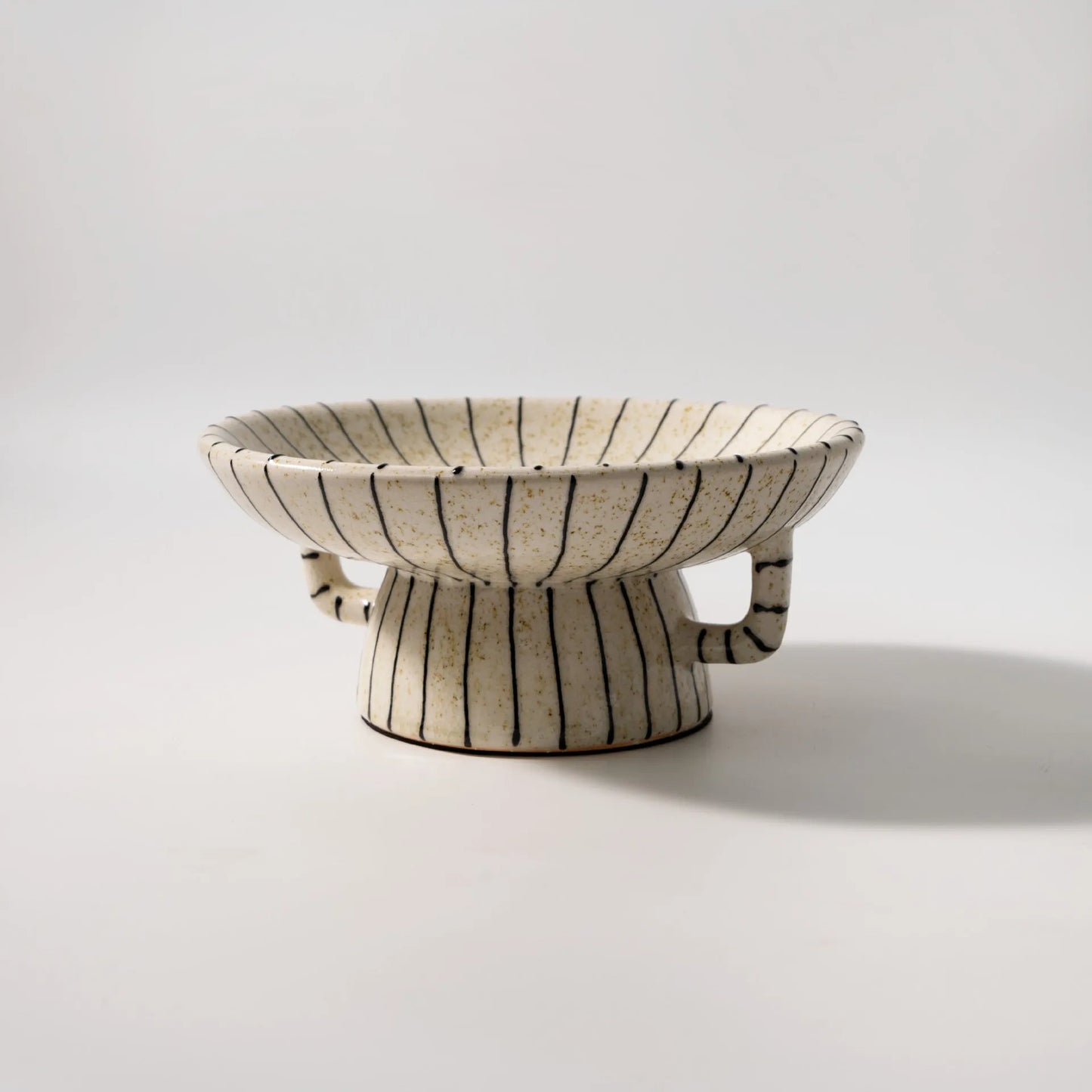 Black and white striped synthetic resin fruit plate with retro fruit motifs, 20cm diameter