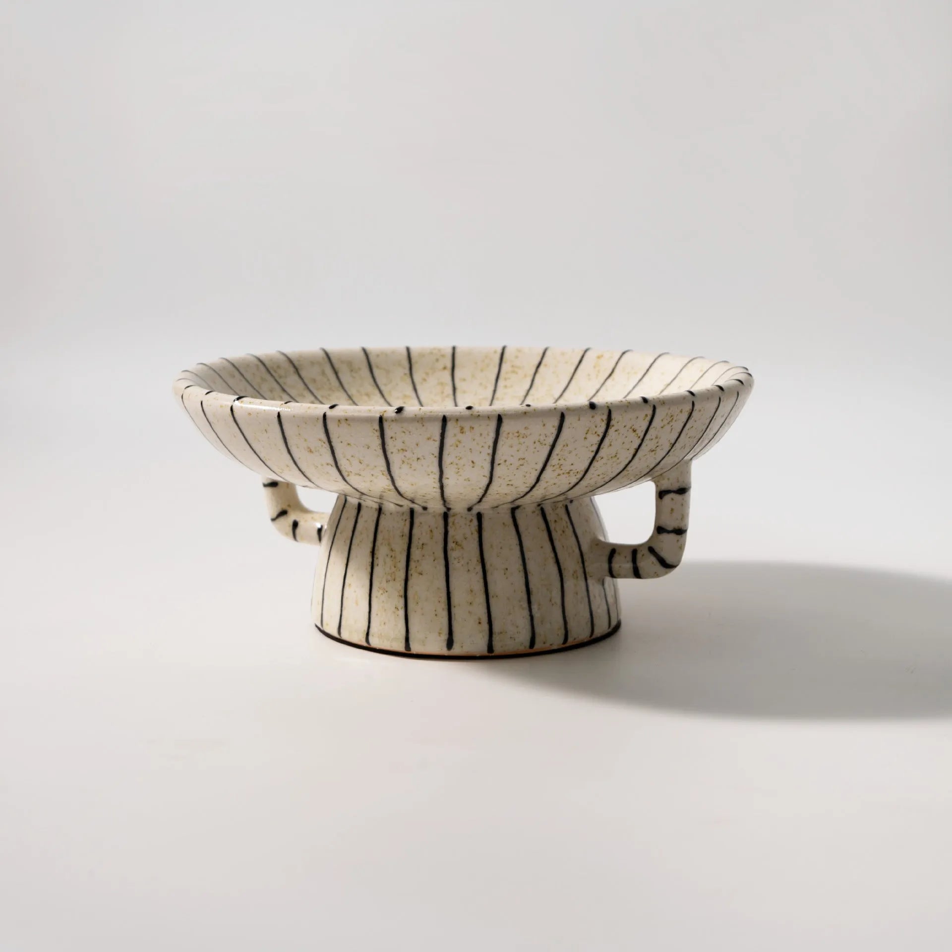 Black and white striped synthetic resin fruit plate with retro fruit motifs, 20cm diameter