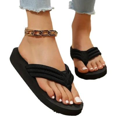 Black women's casual flat slippers with cotton upper and ribbon detail on a solid colour.