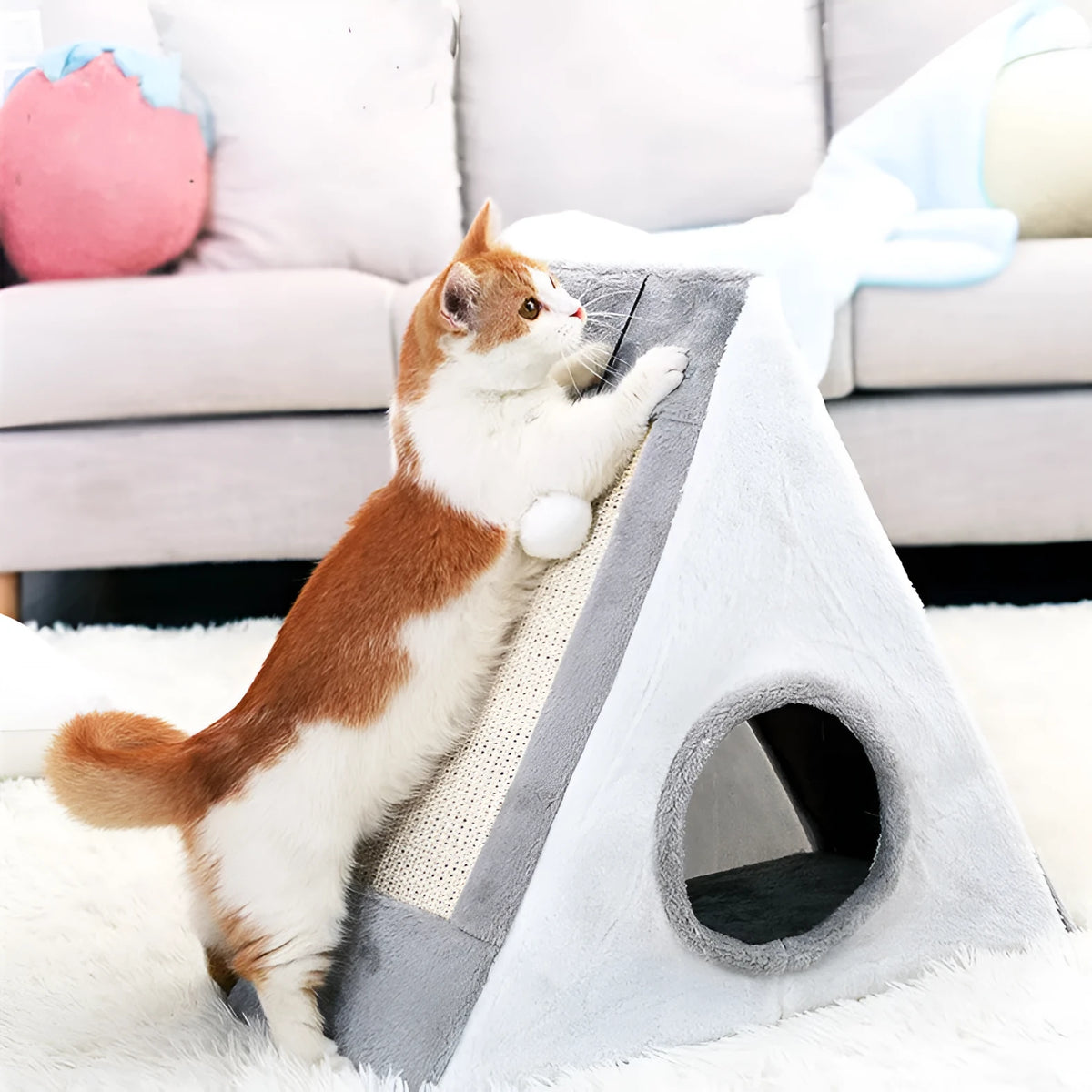 Grey and white triangle-shaped cat scratching post with an integrated soft cat bed.