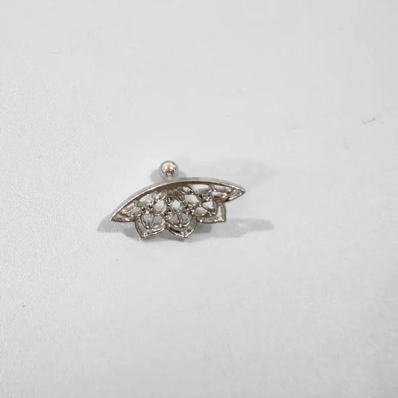 Close-up of a geometric spider web design on a gold-toned metal stud earring.