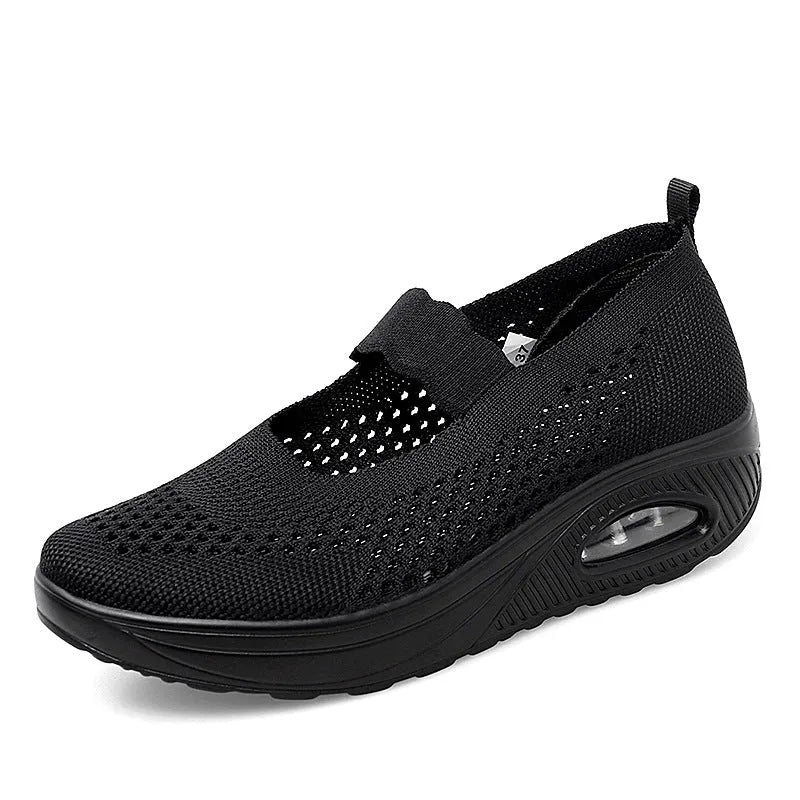 Women's black mesh slip-on casual shoes with round toe and low heel on white background