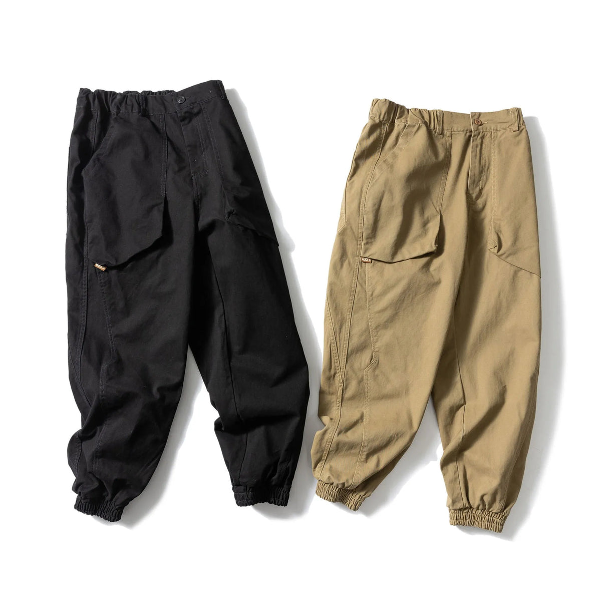 Solid colour cotton casual pants with large pockets and a tapered, ankle-tied silhouette.