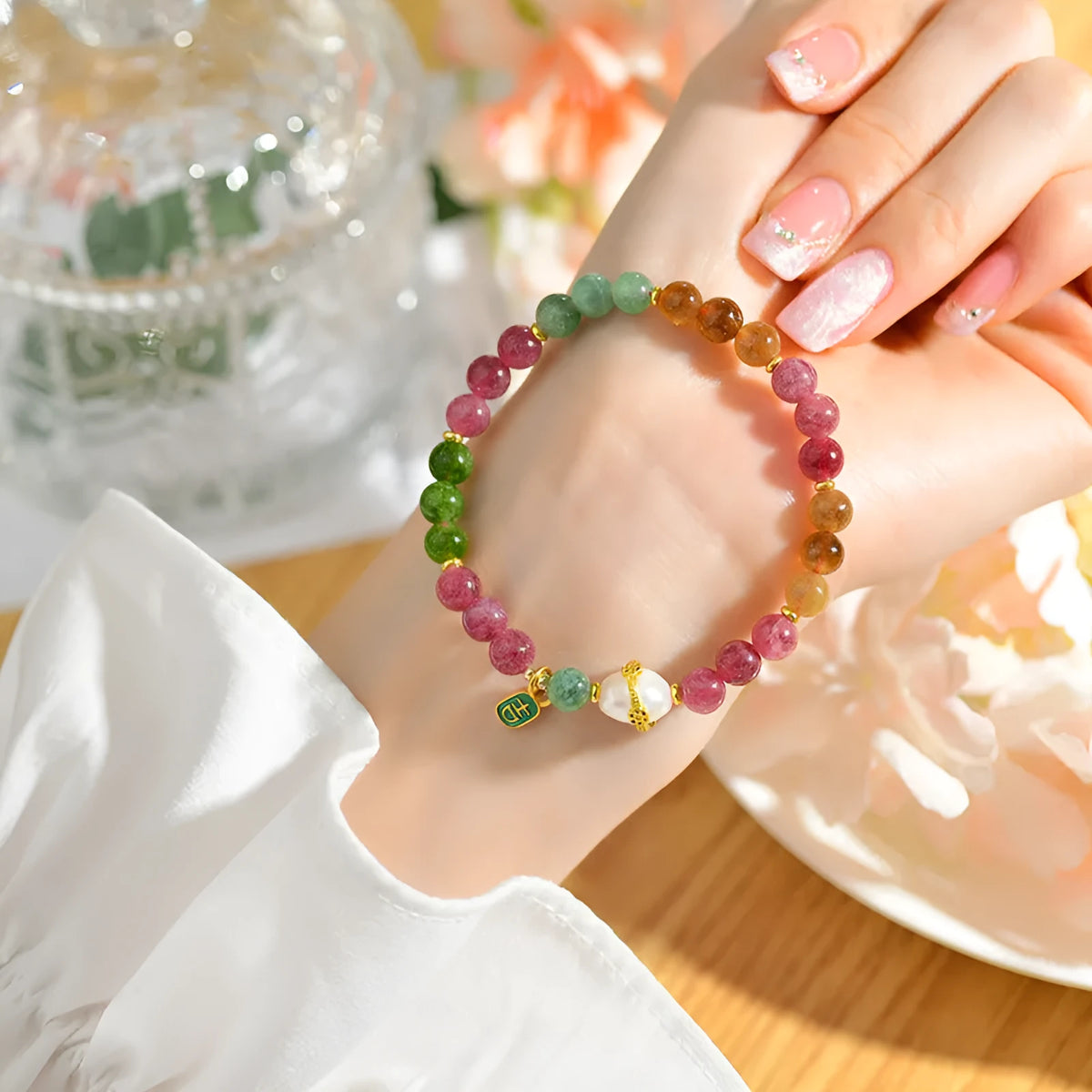 Chalcedony and tourmaline geometric bracelet with 6.5mm beads on a wrist.