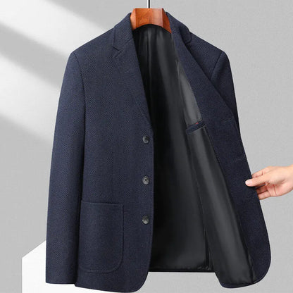 Man wearing a simple, loose-fit solid-colour casual coat in a neutral shade.