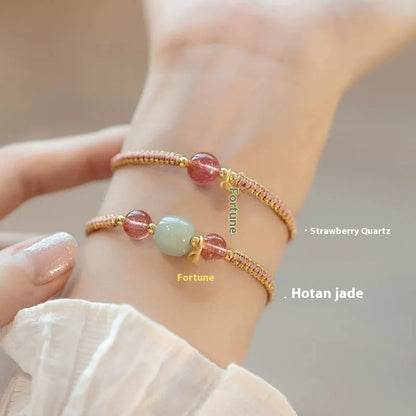 Adjustable red rope bracelet with transfer beads in Strawberry Quartz style on a wrist.
