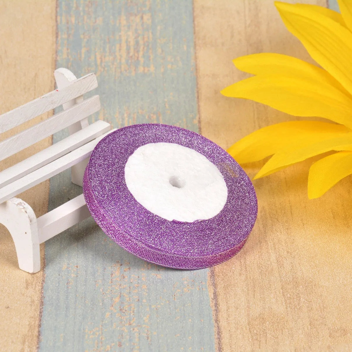 Close-up of green onion patterned ribbon with gold wire on a 25-yard roll, showing 3-points width.