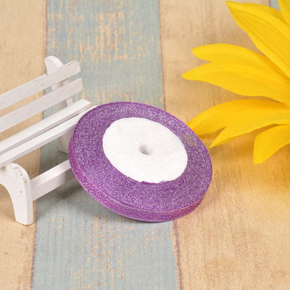 Close-up of green onion patterned ribbon with gold wire on a 25-yard roll, showing 3-points width.