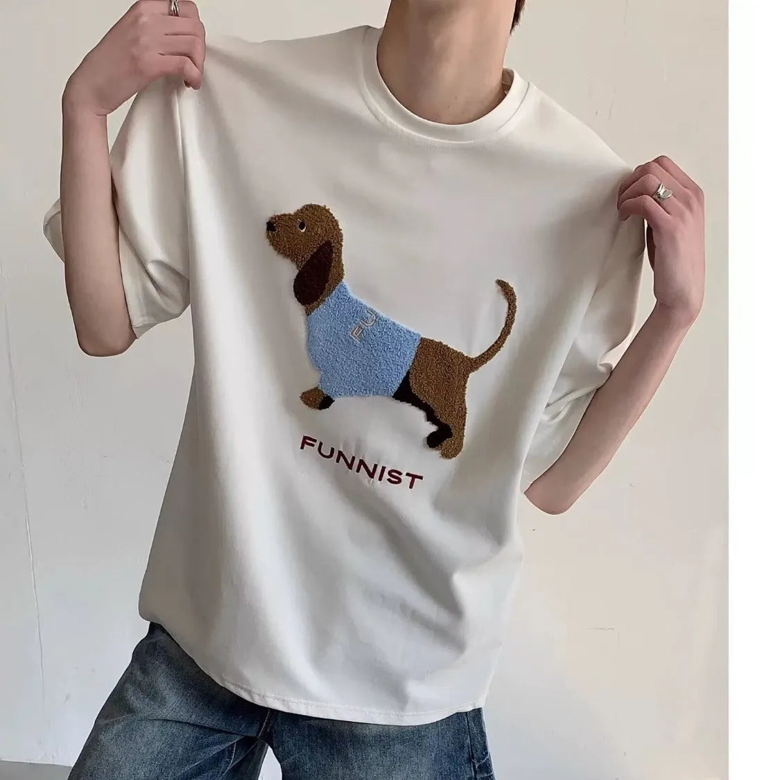 Men's black cotton T-shirt with embroidered sausage dog wrapped in a towel design