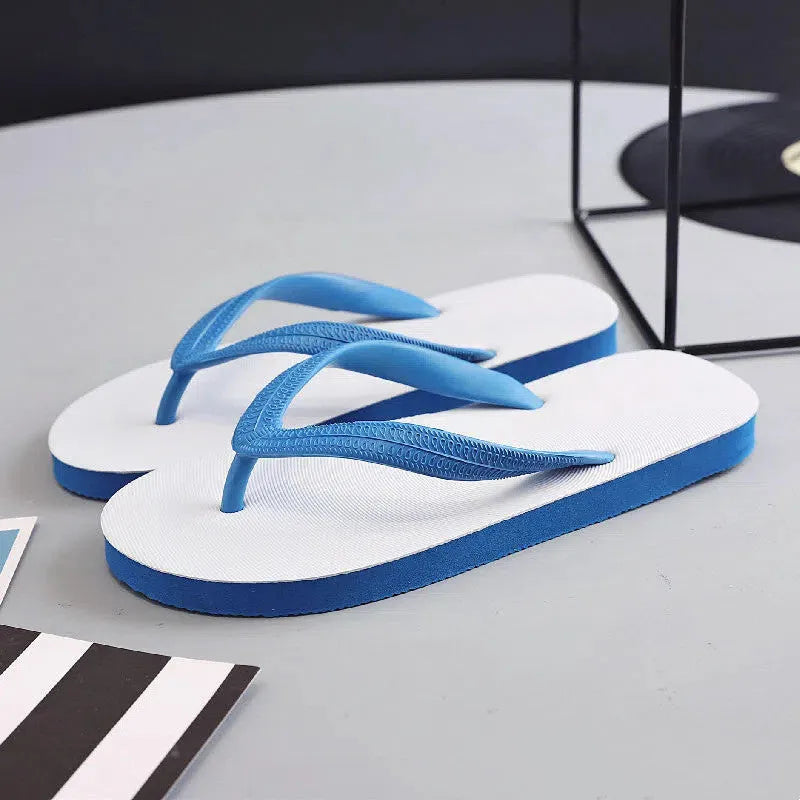 Rubber flip-flops with fish label design on strap, shown in green, red, blue, and black colour options.