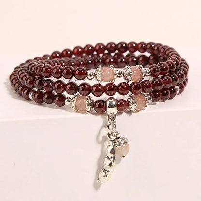 Women's crystal floral bracelet with wine red garnet stones and sauteed green beans detailing