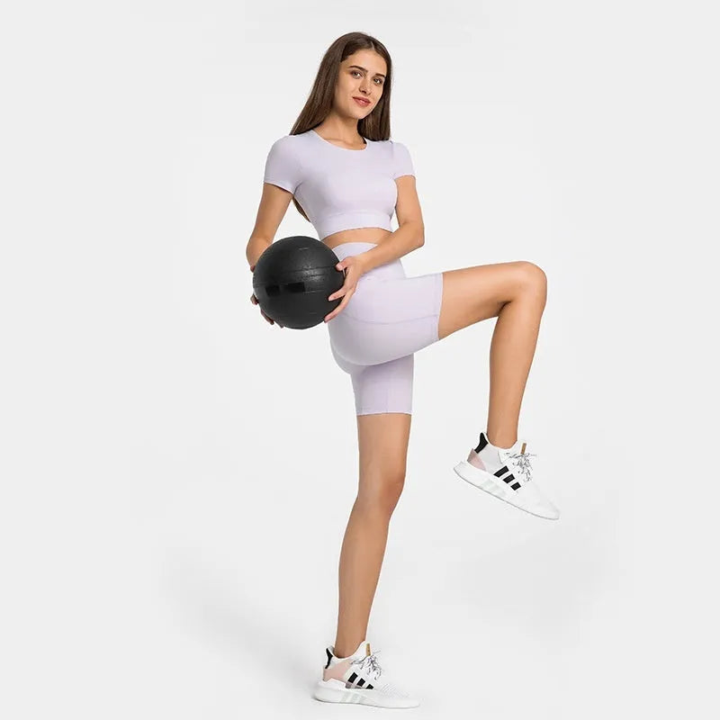 Women's tight-fitting cotton blend sports shorts in black, showing super stretch function and fifth pants length.